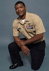 The Navy Service Uniform for junior enlisted sailors (2008) US Navy 080730-N-7090S-004 Personnel Specialist 1st Class Howard Williams models the new E-6 and below Service Uniform (SU). The SU is for year-round wear and replaces summer white and winter blue uniforms.jpg