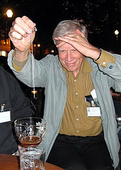 James Alcock dowsing for beer at the 2005 Euroskeptics Conference in Brussels. His lecture was The appeal of alternative medicine. Alcock dowsing for beer.jpg