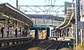 The Nambu Line platforms viewed from a level crossing to the east of the station, January 2014