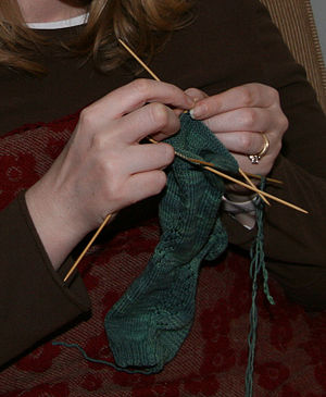 Knitting stockings on double-pointed needles. ...