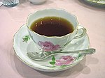 Black tea in a Meissen pink-rose tea cup