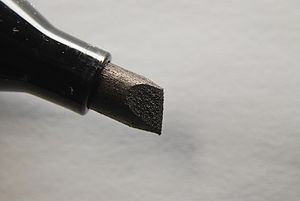 A permanent ink marker featuring a chisel tip....