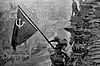 Soviet soldiers raising their flag over the Reichstag