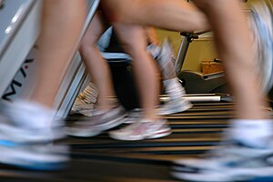 English: Lower legs of several people running ...