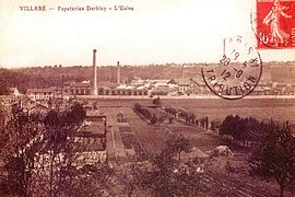 Vue d'une usine et de ses cheminées sur une carte postale des années 1900.