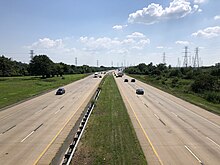 I-495, the largest highway passing through the city, bypasses downtown to the east along the shore of the Delaware River 2022-07-20 15 31 33 View south along Interstate 495 (Wilmington Bypass) from the overpass for East 12th Street in Wilmington, New Castle County, Delaware.jpg