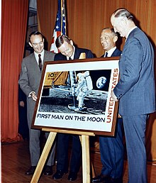 Apollo 11 astronauts unveiling First Man on the Moon stamp with U.S. Postmaster General Winton M. Blount Apollo 11 crew unveiling stamp (69-HC-1119).jpg