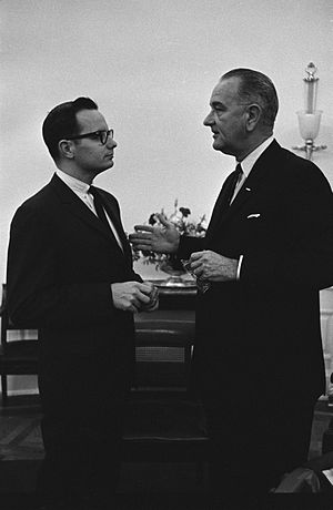 US President Lyndon Johnson (right) meets with...