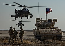1st Armored Division infantry, an M2 Bradley armored vehicle, and AH-64 Apache attack helicopters as part of Combined Joint Task Force - Operation Inherent Resolve in Syria M2 Bradley Infantry Fighting Vehicles in Northeast Syria 2020.jpg