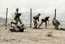 Members of the regiment in a live fire demonstration during Operation Desert Shield. Members of the 1st Battalion, 325th Airborne Infantry Regiment, make their way through concertina wire.JPEG