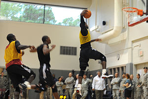 LeBron James (right) prepares to dunk a basket...