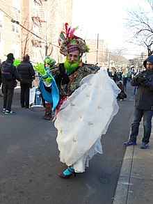 Ms Colombia with a beard dyed green and in a white fabric