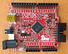 A PCB with red solder mask and white silkscreen OLIMEXINO-32U4.jpg