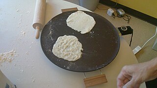 Two lefse cooking on a Heritage grill.