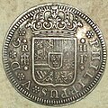 Reverso de moneda de 2 reales (plata) de Felipe V con "ceca" de Segovia del año 1723.