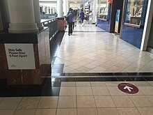 Floor decals and signs promoting one-way traffic and social distancing at the King of Prussia mall in King of Prussia, Pennsylvania King of Prussia Mall social distancing.jpeg