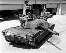 An M1A1 in U.S. Army service at Fort Knox, Kentucky in 1988. Manning a .50 cal on M1A1 Abrams main battle tank Fort Knox.jpg