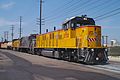 An NRE 3GS21B leads a Union Pacific train along street running trackage at Anaheim, California.