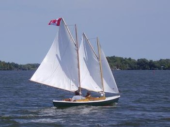 Reaching: the pennant is streaming slightly to the side as the sails are sheeted to align with the apparent wind.