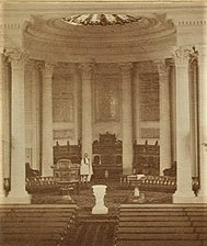 St. Luke's Church interior, view towards chancel. Rev. Howe standing in chancel in vestments, c.1868