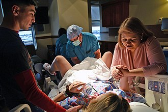 Intended parents attend the birth of their child by a gestational surrogate. Surrogate parents attending birth.jpg