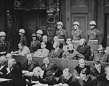 Defendants at the Nuremberg trials listening to translated evidence through headphones The defendants at Nuremberg Trials.jpg