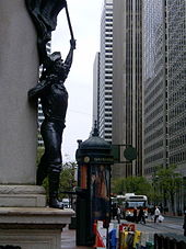 Another view of Market Street in downtown San Francisco, taken near the intersection with Montgomery Street, looking northeast toward the Ferry Building. The foreground bronze is entitled Admission Day, by Douglas Tilden. Tilden Admission Day Monument.jpg