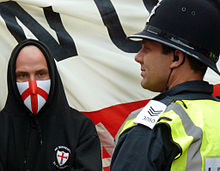 An EDL supporter and a police officer at an EDL march in Newcastle in 2010 EDL4.jpg