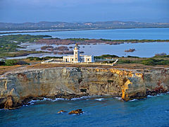 View of the lighthouse with Laguna Sucia in the background.