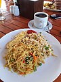 Nasi goreng and bihun goreng served with coffee at breakfast in an Indonesian hotel.