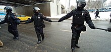 Policemen made a chain with batons.jpg