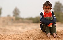 A boy displays an angry pout. Pouting boy in Shamar, Iraq.jpg