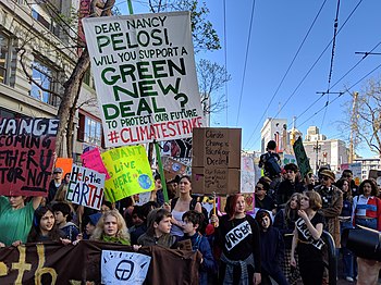 School strike in San Francisco on 15 March 2019, with a placard demanding economic action be taken in response to climate change. San Francisco Youth Climate Strike - March 15, 2019 - 22.jpg