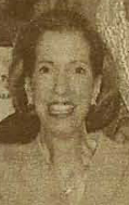 A sepia-colored newspaper photograph of a smiling white woman.