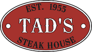 Tad's logo. Red oval with "TAD'S" in the middle, "Est. 1955" at tope and "STEAK HOUSE" on the bottom.
