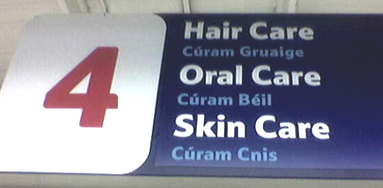 A bilingual sign in a Tesco supermarket in Dublin, Ireland. Note the smaller, shaded-out Irish language text compared to the prominent English text
