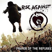 The back of a man is seen while he is jumping in front of a crowd. To the right of the man, there is a drawing of a fist in front of a heart, with the text "RISE AGAINST" above it. In the lower right corner, the text "PRAYER OF THE REFUGEE" is displayed.
