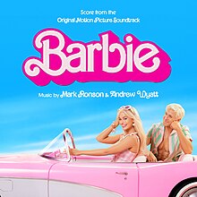 A photo of Margot Robbie's Barbie and Ryan Gosling's Ken sat in a pink car, with a cloudy blue sky background.