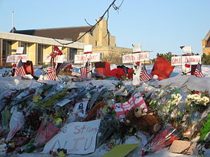 Crosses, flowers, signs, and other items left ...