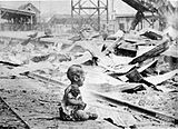 Photo taken by H.S. Wang, a Chinese American photographer, in the ruins of Shanghai and first appeared in Life magazine on October 4, 1937. This became one of the most influential photos to stir up anti-Japanese feeling in the USA, and is still used to show Japanese atrocities in relation to the Nanking Massacre. Later, a correspondent of the Chicago Tribune presented other photos taken at the same hour and same place, showing evidence that this had been a staged photo: the baby was brought there by the photographer to create a dramatic photo.[195]