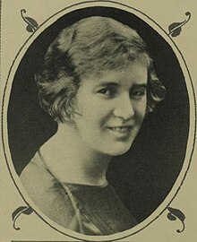 A white woman with short fair hair, in an oval frame