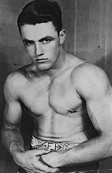 Wrestler Stu Hart wearing an amateur wrestling championship belt, sometime between 1933 and 1936.jpg