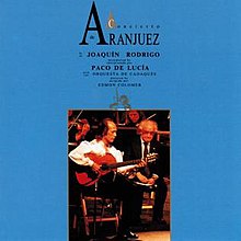 Blue background with inset photo of man playing flamenco guitar on stage with orchestra.