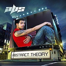 An image of a man wearing a sleeveless red shirt and blue jeans is shown on a building. The album title is placed below it on a billboard and the artist's logo is on the upper left corner of the cover.