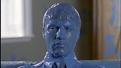 A man is covered in blue paint.