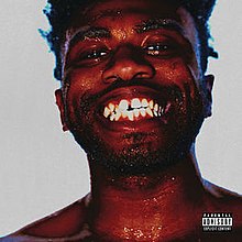 Uncentered closeup photograph of Kevin Abstract grinning with heavily affected colours and contrast