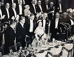 Queen Elizabeth The Queen Mother attends the university's bicentennial Charter Day Dinner, standing beside Dag Hammarskjöld, Philip Jessup, and Grayson Kirk.