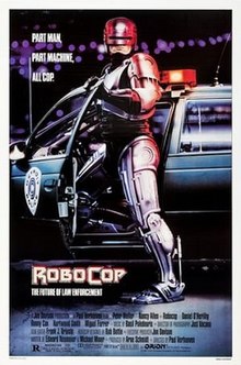 The film's titular character, a cyborg clad in metallic armor, stands in front of his police car. The tagline reads "Part Man, Part Machine, All Cop."
