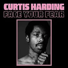Black-and-white photograph of a man looking into the camera with the words "Curtis Harding" and "Face Your Fear"