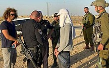 Hayim Katsman (far left) volunteering in the West Bank to reduce tension between settlers and Palestinians.jpeg